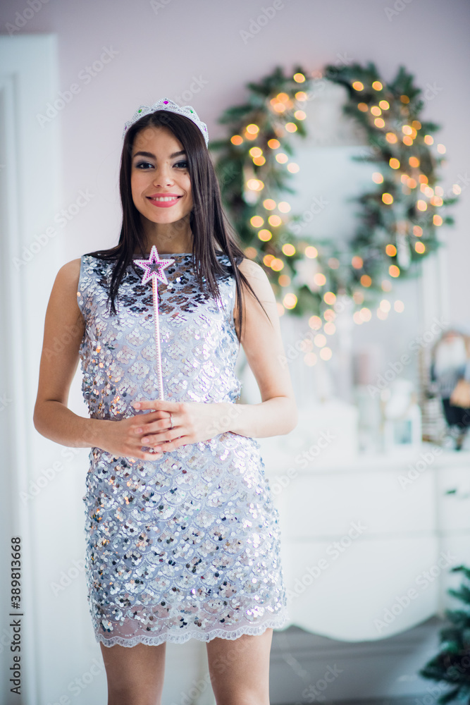 Beautiful young woman in Santa Claus clothes over Christmas background. Beautiful young woman in Santa Claus clothes over Christmas background.