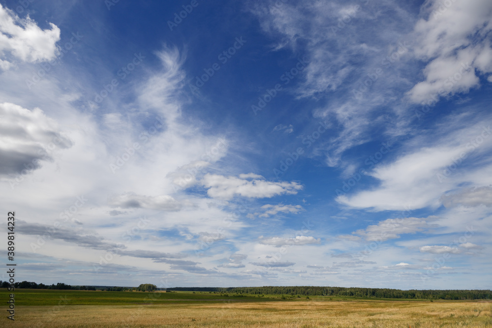 blue sky with variegated clouds over the field blue sky with variegated clouds over the field