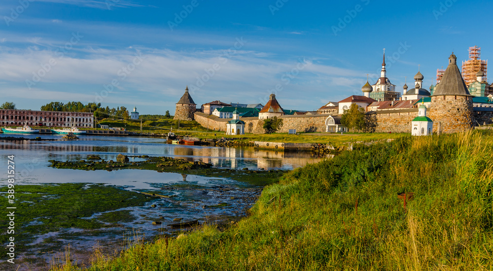 Evening view of the Solovetsky Monastery (Kremlin) at low tide at sea.