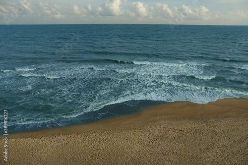 Sea with waves on beautiful sandy beach
