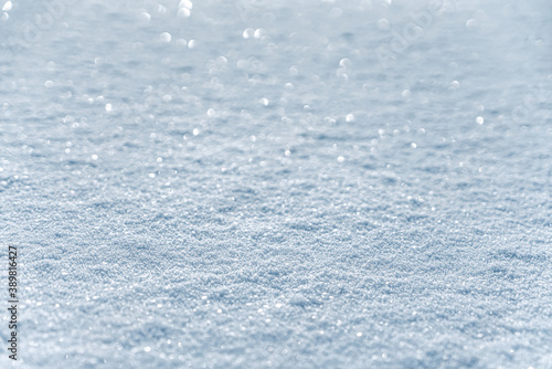 Winter snow. Snow texture with bokeh, light, selective focus. Snowy white texture. Snowflakes