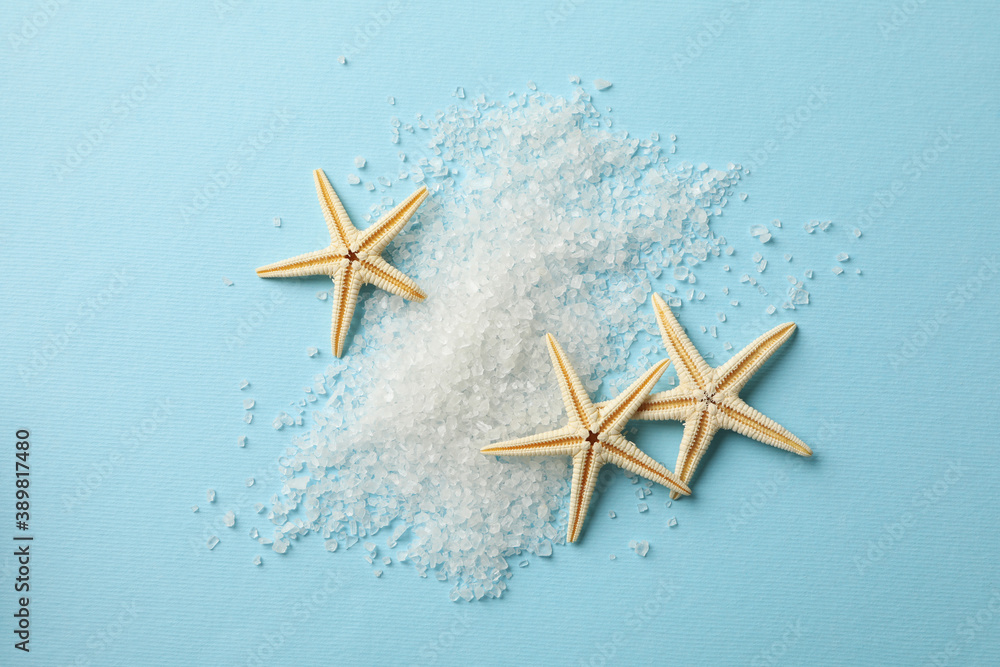 Stack of salt and sea stars on blue background Stack of salt and sea stars on blue background