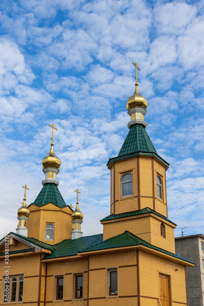 The building of the Orthodox Church against the background of the sky and clouds. Church of St. Sergius of Radonezh, city of Magadan, Magadan Region, Russian Far East, Siberia.