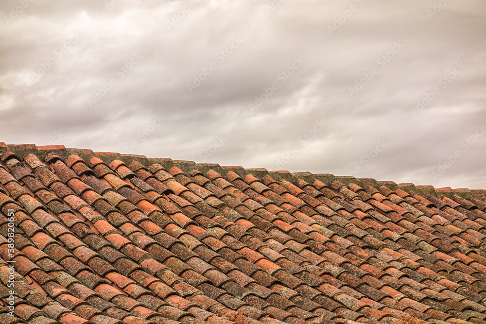 Roof of a house with cloudy sky. Roof of a house with cloudy sky.