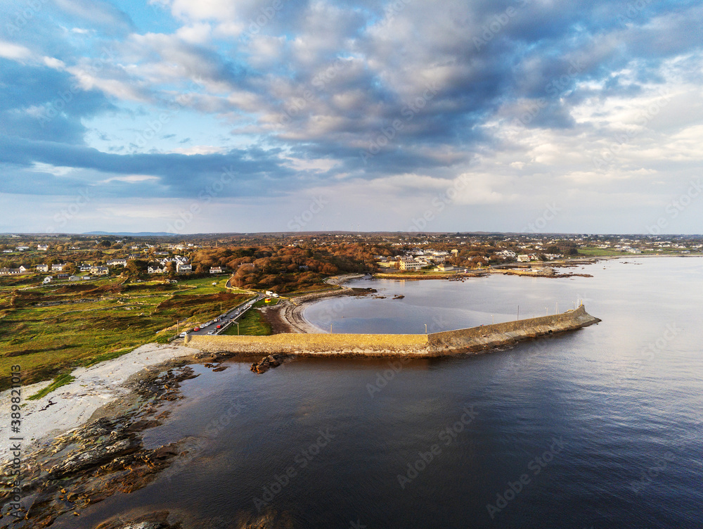 Aerial drone view on a Spiddal stone pier. County Galway, Ireland. Cloudy sky. Popular beach and walking spot and fishing location