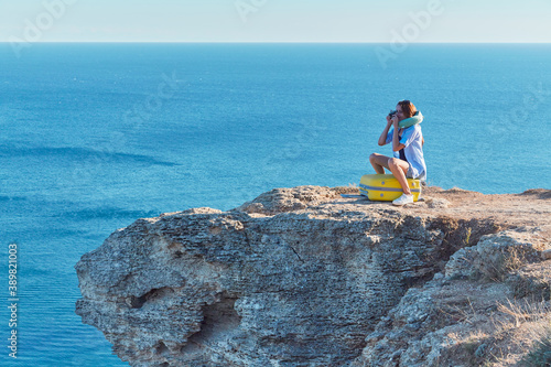 Lady taking picture of nature on photocamera. Ocean view and relax. New ground and business travel concept, copy space