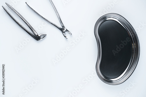 Photo of kidney-shaped bowl with dental tools photo