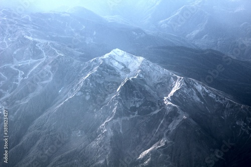 view of the snowy mountains from the plane window