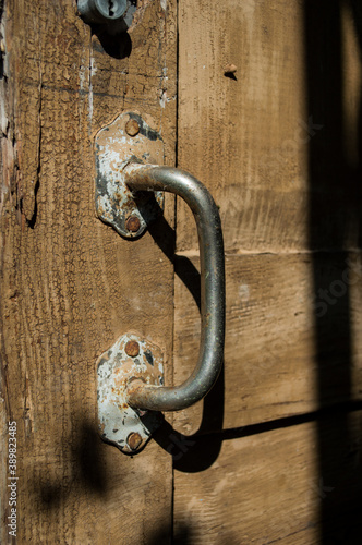 Old doorknob on a wooden door