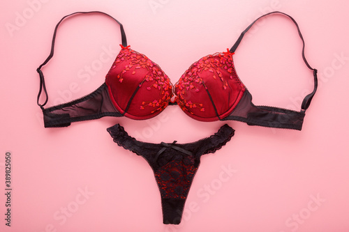 Принти на полотні Female black red bra and string panties on light pink table background