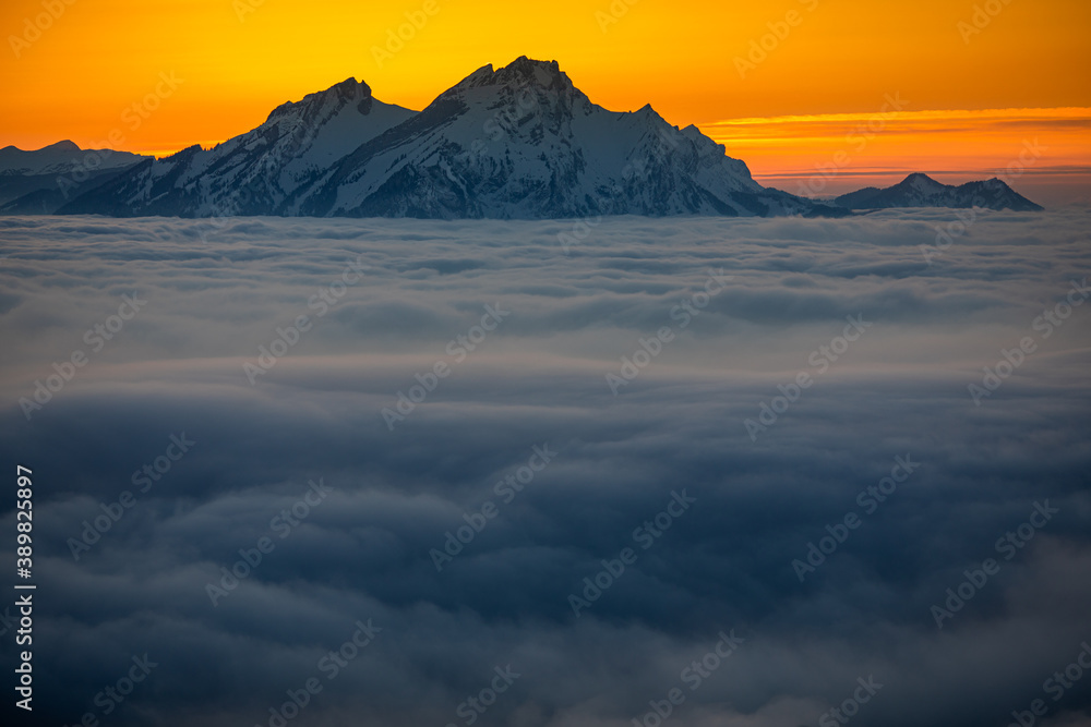 Splendid apline scenery. High mountains with fog and lovely evening light.