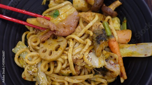 Eating prok and fried noodle with mala pepper Chinese sichuan cuisine spicy and numb food top view photo