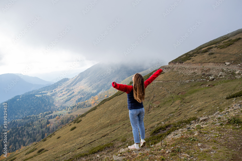 Obraz premium Young woman on a mountain hike in Sochi, Russia.