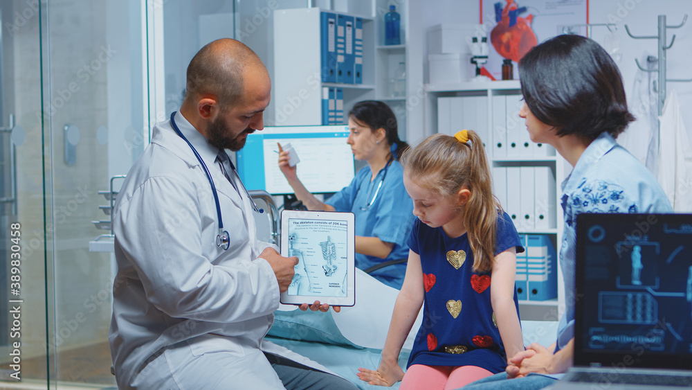 Doctor showing skeleton graphics on tablet during consultation. Healthcare practitioner physician specialist in medicine providing health care service radiographic treatment examination in hospital