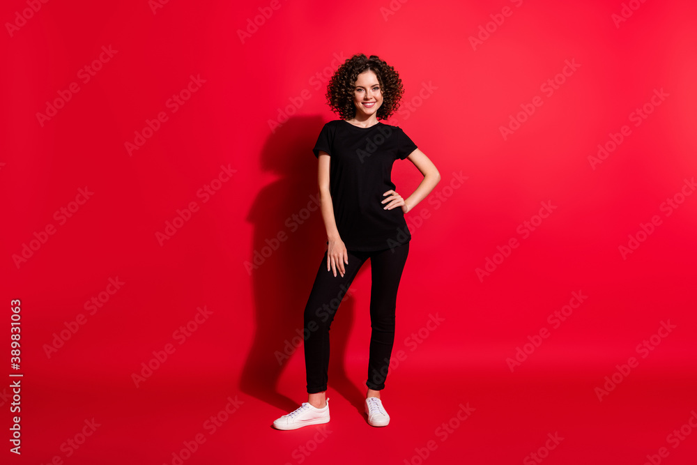 Full length body size photo of young beautiful woman curly brown hair wear casual outfit isolated over red color background