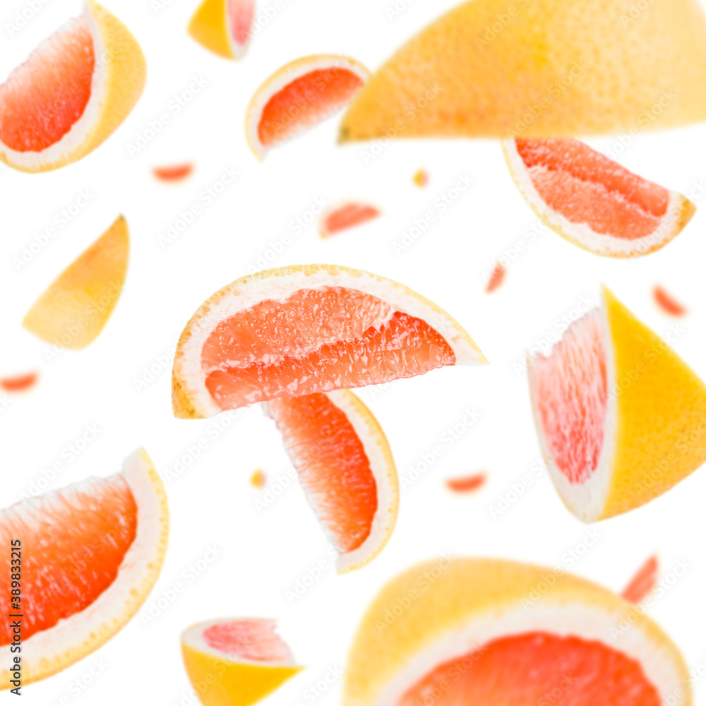 Many slices of blood orange free falling on white background. Selective focus - shallow depth of field. Many slices of blood orange free falling on white background. Selective focus - shallow depth of field.