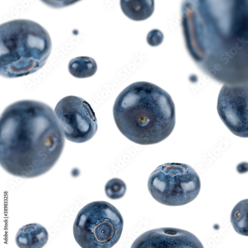 Many blueberries free falling on white background. Selective focus - shallow depth of field.