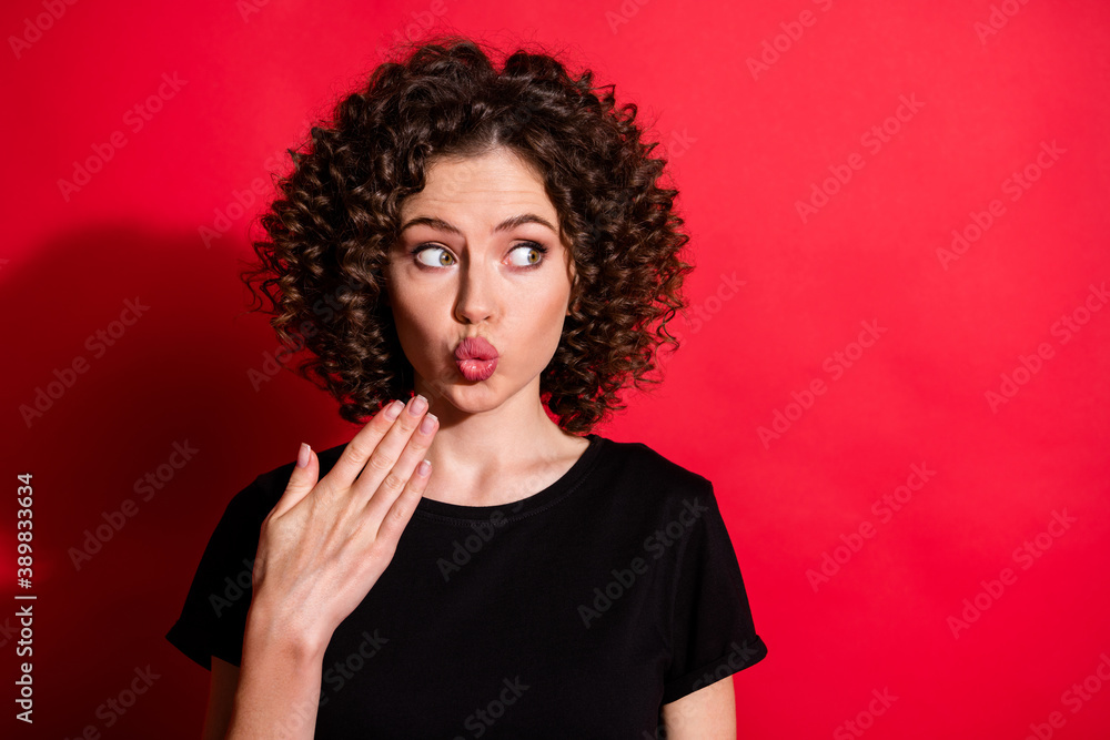 Close-up portrait of lovely shy flirty wavy-haired girl pout lips looking aside copy space isolated over bright red color background Close-up portrait of lovely shy flirty wavy-haired girl pout lips looking aside copy space isolated over bright red color background