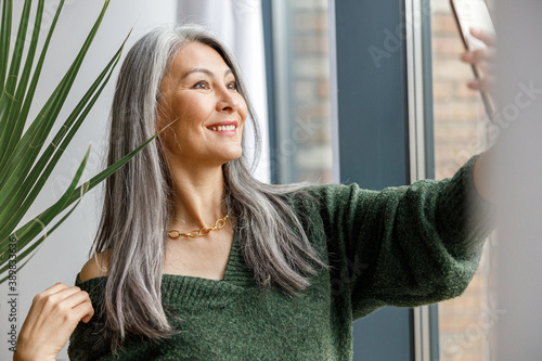 matured beautiful asian paled hair woman at home