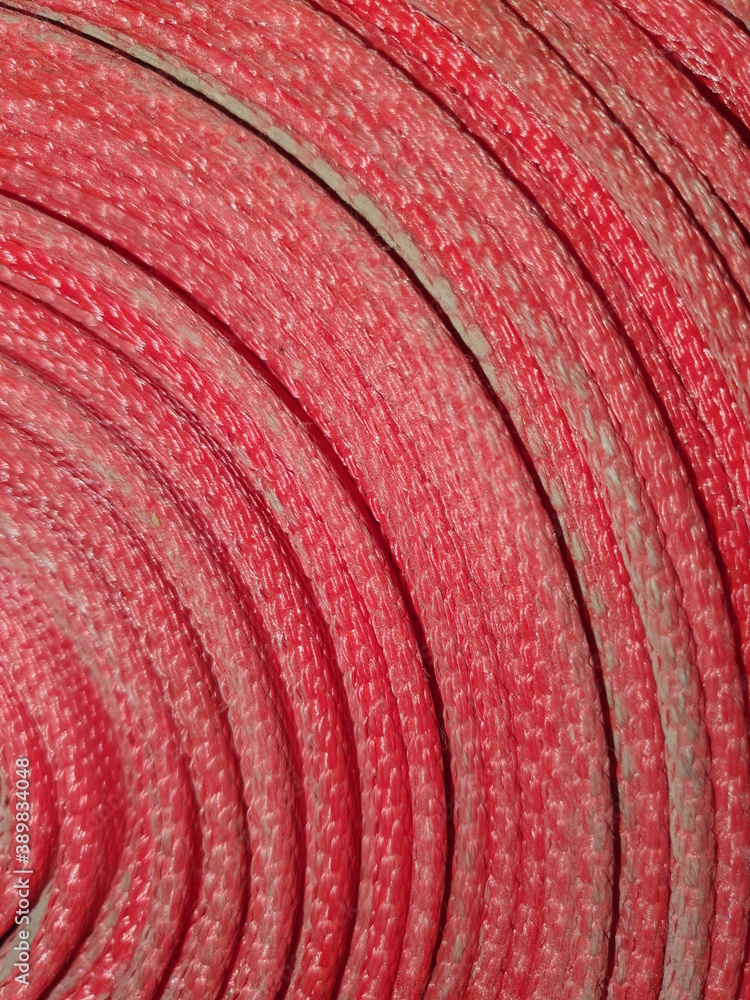The texture of the twisted red fire hose. The texture of the twisted red fire hose.
