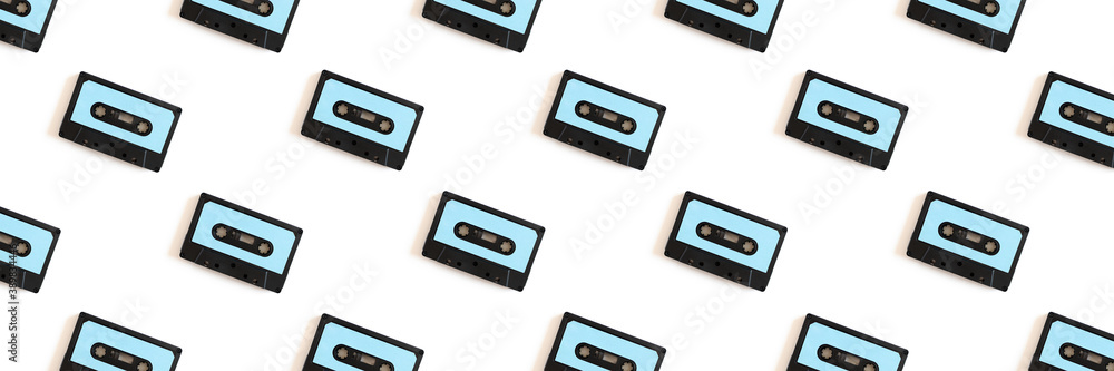 Fototapeta premium Cassette tapes pattern on a white background. Creative banner concept.