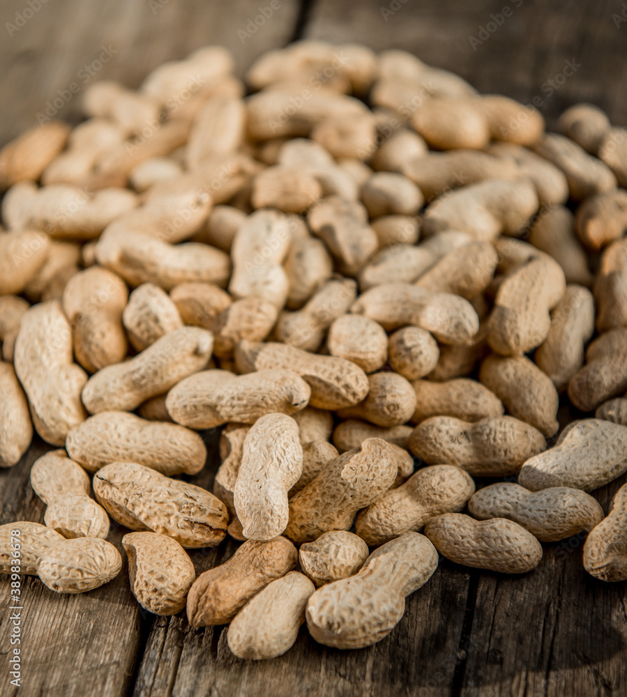 Dried peanuts closeup photo. Peanut in the shell. Food background of peanuts, healthy vegan food Dried peanuts closeup photo. Peanut in the shell. Food background of peanuts, healthy vegan food