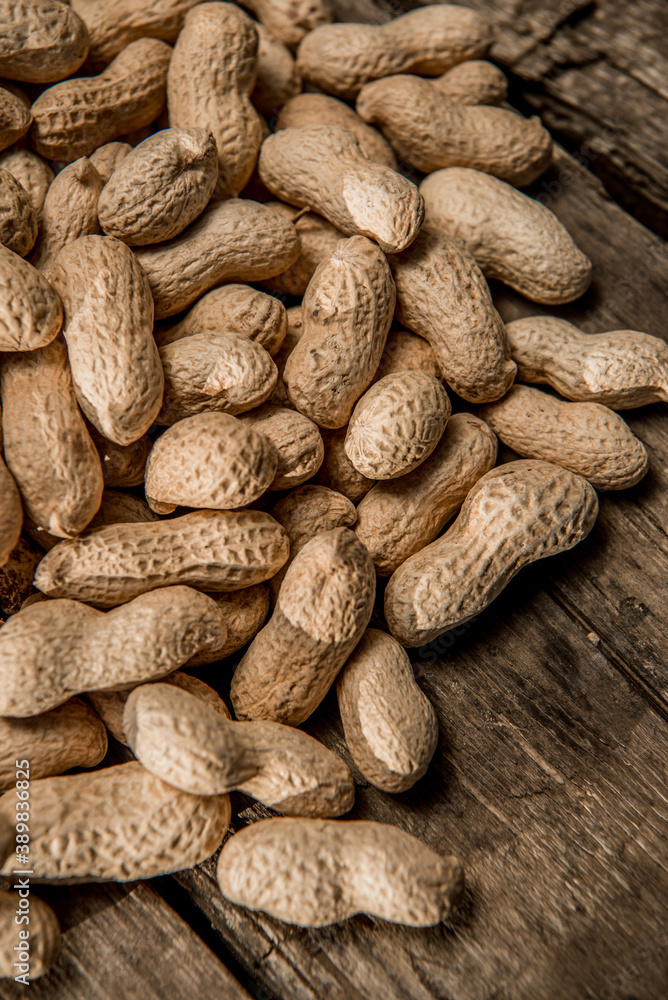 Dried peanuts closeup photo. Peanut in the shell. Food background of peanuts, healthy vegan food Dried peanuts closeup photo. Peanut in the shell. Food background of peanuts, healthy vegan food