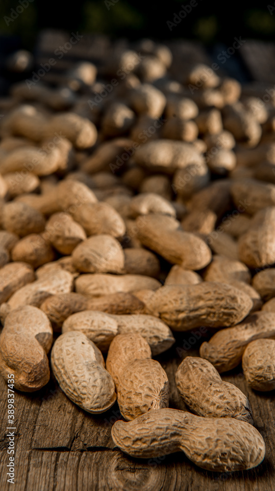 Dried peanuts closeup photo. Peanut in the shell. Food background of peanuts, healthy vegan food Dried peanuts closeup photo. Peanut in the shell. Food background of peanuts, healthy vegan food