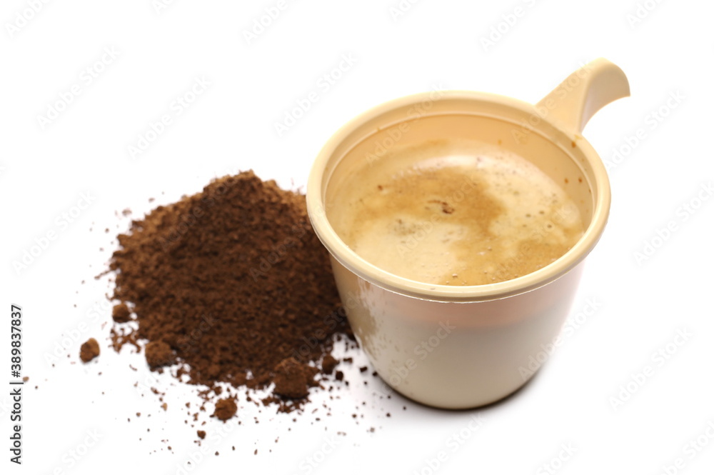 Milled coffee with full plastic cup, mug isolated on white background Milled coffee with full plastic cup, mug isolated on white background