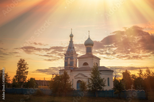 orthodox old church in the village at sunset photo