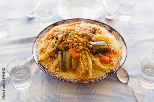 Photos Foodie design elements friday gathering family size delicious couscous plated with stew, vegetables and beef with spoons