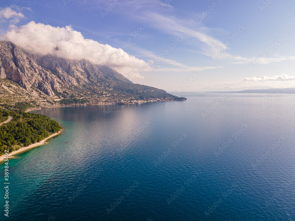 Amazing view at Makarska rivera beaches with apartments in Makarska Riviera. Podgora-Caklje area with high mountain Biokovo in background. Drone view. Croatia, Dalmatia