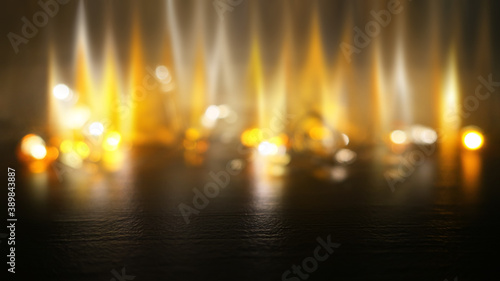 Dark abstract background with neon blurred golden lights. Reflection on the surface of the golden bokeh. Flames  smoke  fire.