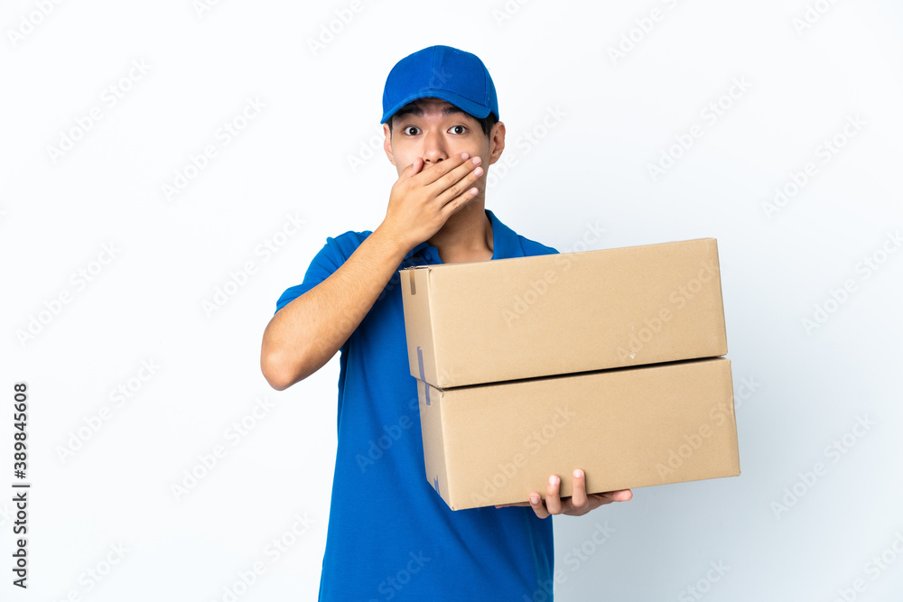 Delivery Chinese man isolated on white background covering mouth with hands Delivery Chinese man isolated on white background covering mouth with hands