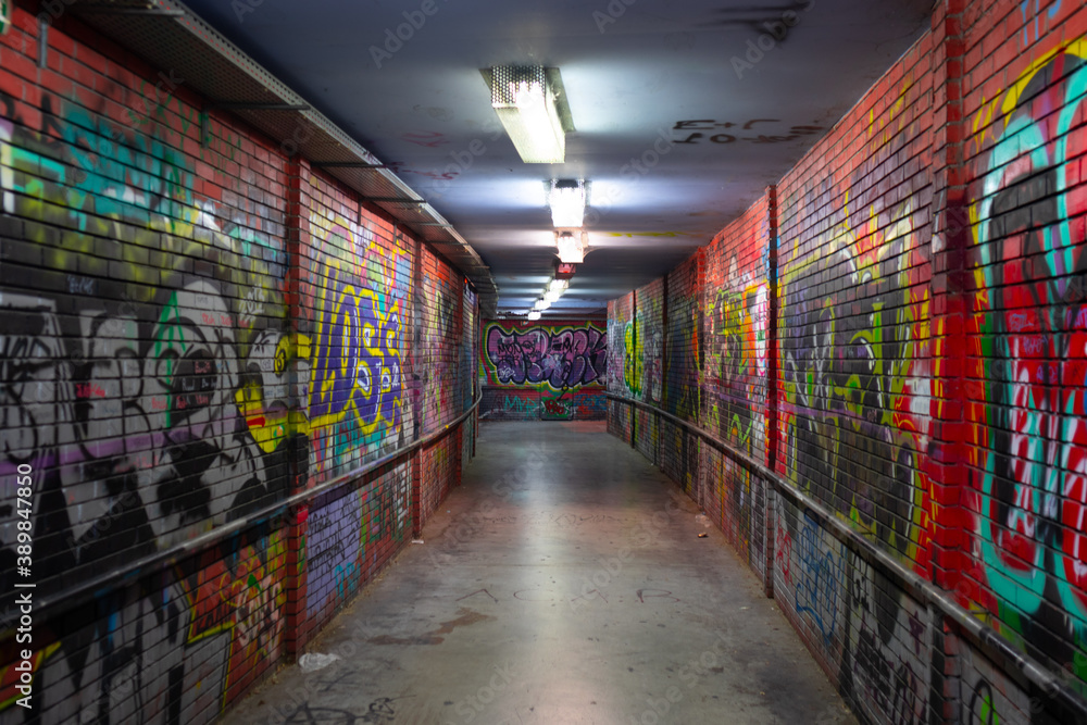 Abandoned underground passage with bright orange graffiti Abandoned underground passage with bright orange graffiti