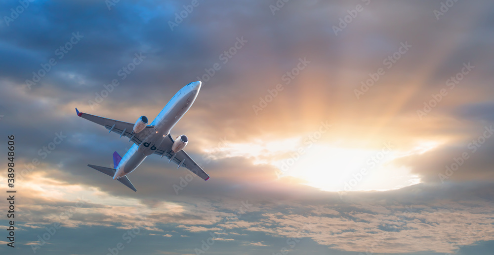 White passenger airplane over the clouds - Travel by air transport White passenger airplane over the clouds - Travel by air transport