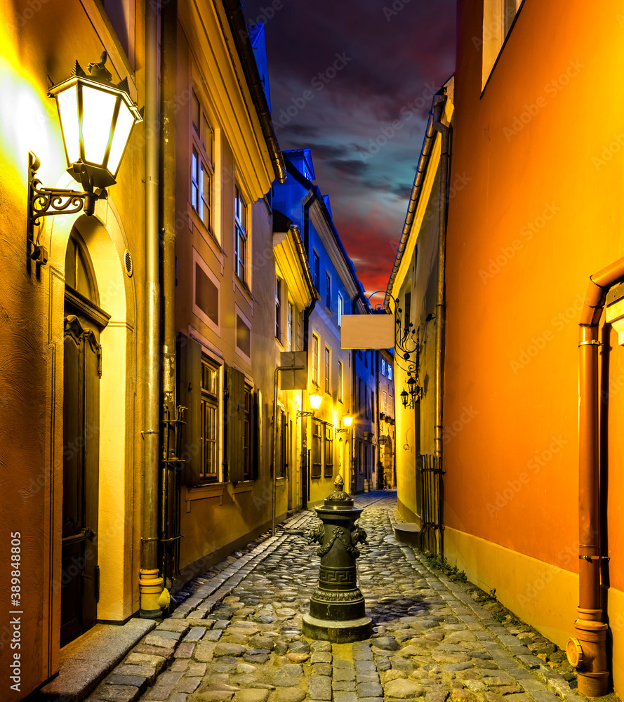 Narrow medieval street at night, old district in European town - obrazy, fototapety, plakaty 
