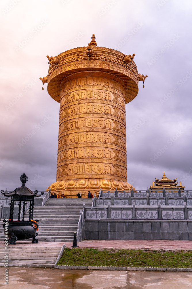 The big golden rolling prayer drum in the tibetan buddhist monastery