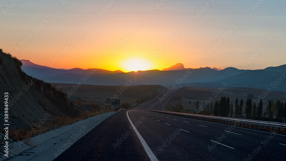 Curve asphalt highway road at amazing sunset