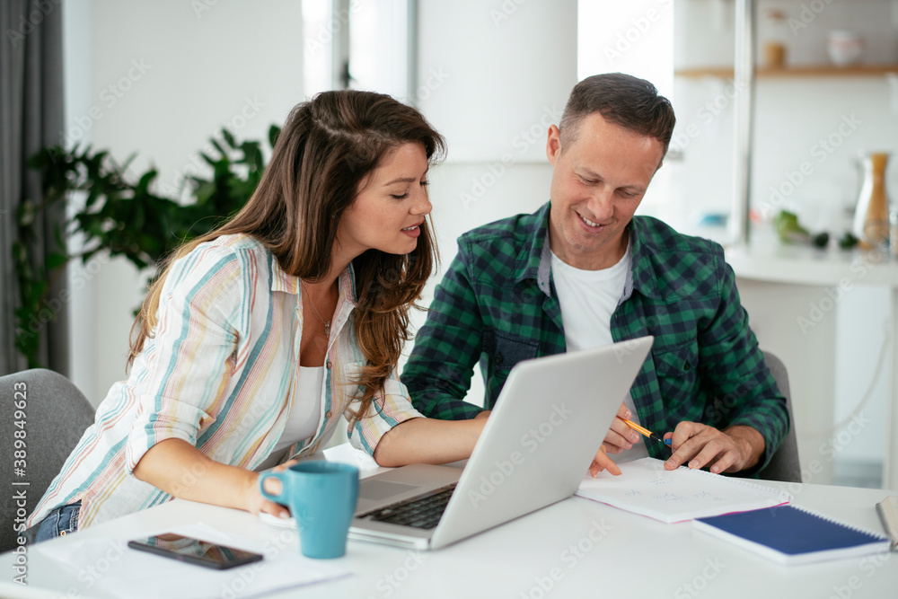 Husband and wife preparing bills to pay. Young couple using laptop. Husband and wife preparing bills to pay. Young couple using laptop.
