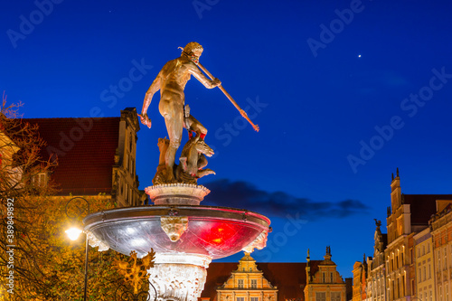 Beautiful architecture of the old town in Gdansk with Neptune fountain at night, Poland