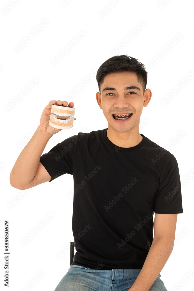 Young asian man smiling with denture Young asian man smiling with denture
