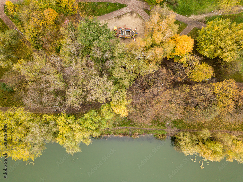 Aerial drone view. Autumn trees on the background of the city lake. Aerial drone view. Autumn trees on the background of the city lake.