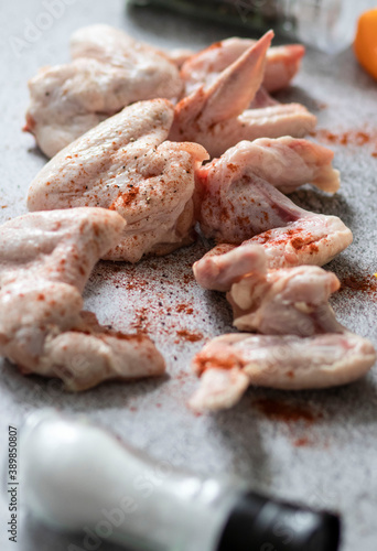 
raw chicken wings on gray background