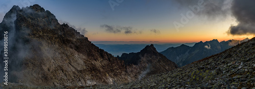 At the top of the highest mountain in polish High Tatras mountains Rysy at hight 2499m above sea level during a beautiful sunset.