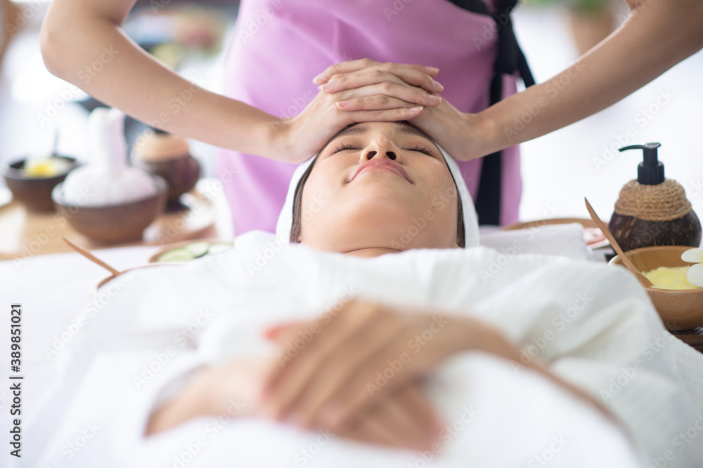 Therapist use her hand touch client forehead for treament Therapist use her hand touch client forehead for treament