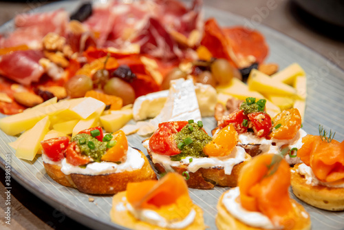 close up of bruschetta on variety of italian cold cut board