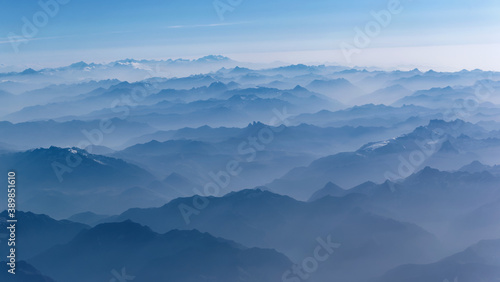 Aeria view of the blue foggy Alps mountains