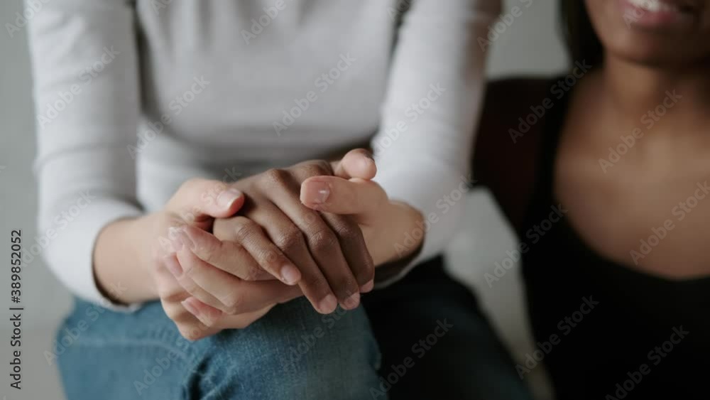 Female hands close up. Mixed race lesbian couple holding hands Female hands close up. Mixed race lesbian couple holding hands