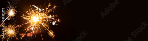 Silvester   New year background - People hold sparkling sparkler in her hand at dark night